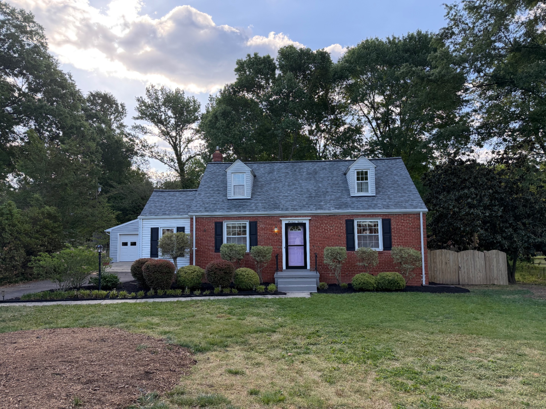 After: cleaner front beds, sharper shrubs, and improved curb appeal