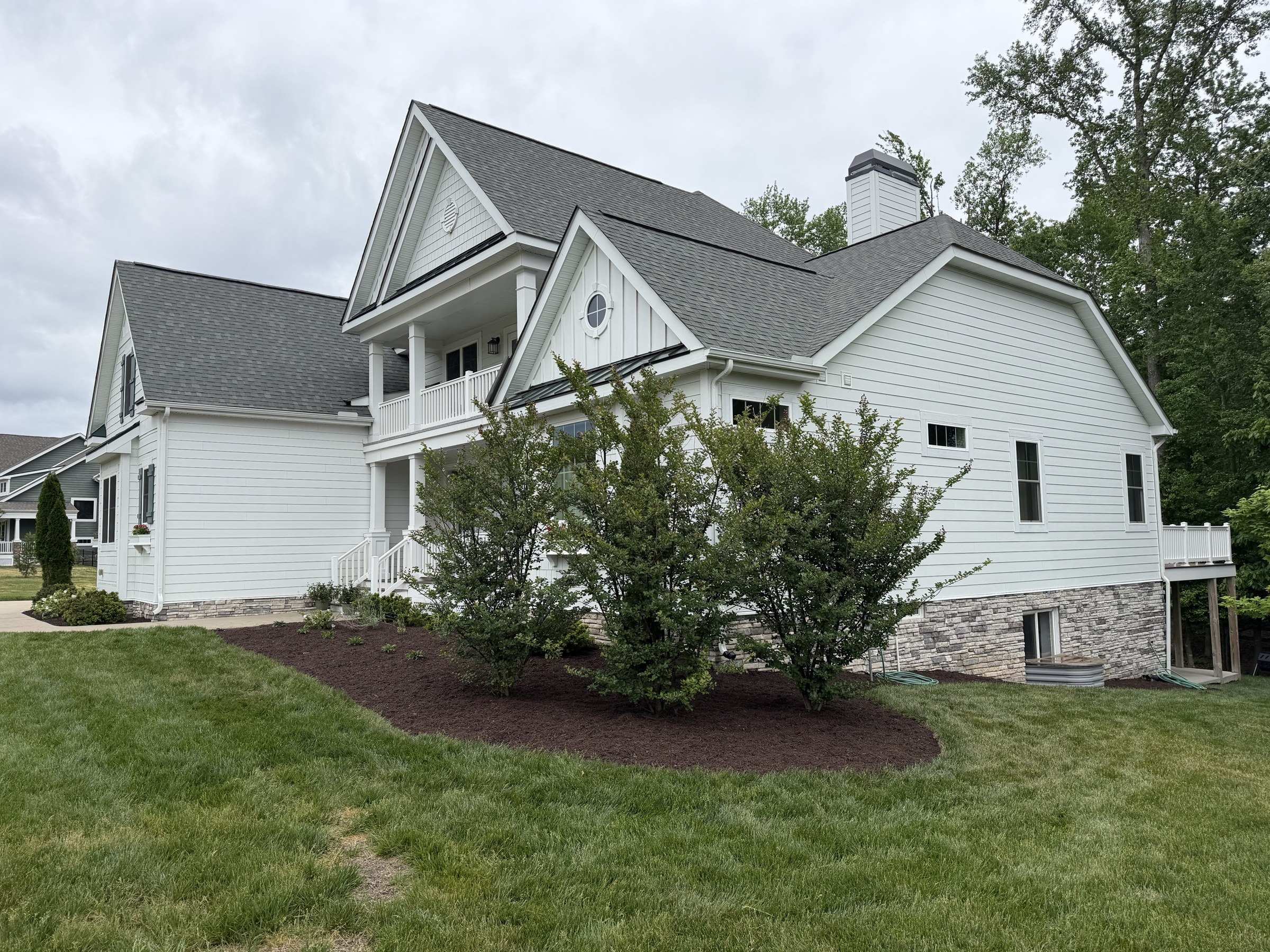 After: restored lawn, pruned shrubs, fresh mulch & crisp bed lines